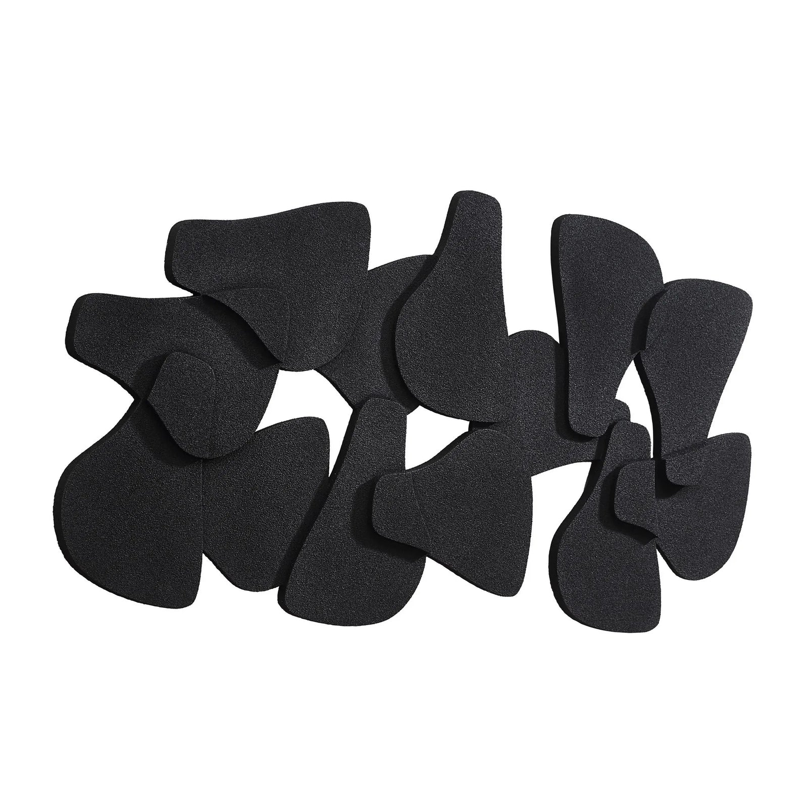A collection of black, irregularly shaped biscuit accent wall decor pieces