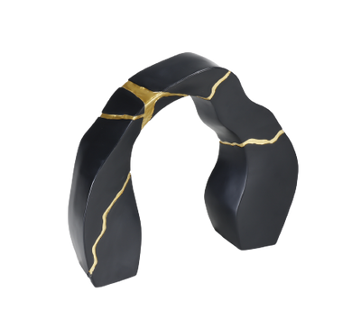 A black and gold statue decor object with a textured surface and a broken gold statue piece attached to the main body.