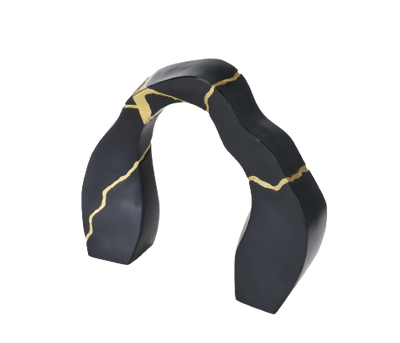A black and gold statue decor object with a textured surface and a broken gold statue piece attached to the main body.