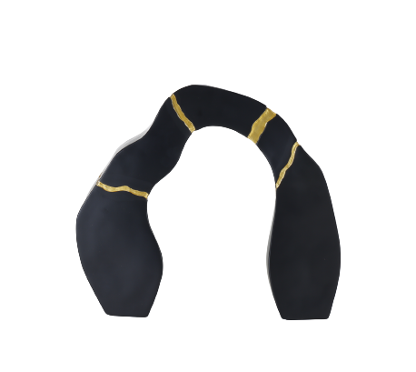 A black and gold statue decor object with a textured surface and a broken gold statue piece attached to the main body.