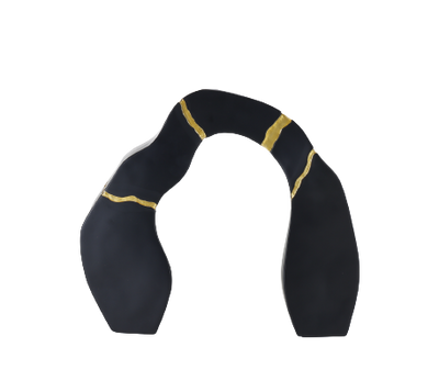 A black and gold statue decor object with a textured surface and a broken gold statue piece attached to the main body.