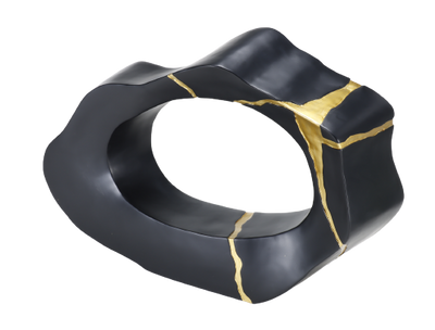 A black and gold decorative statue with a smooth finish and geometric shape.