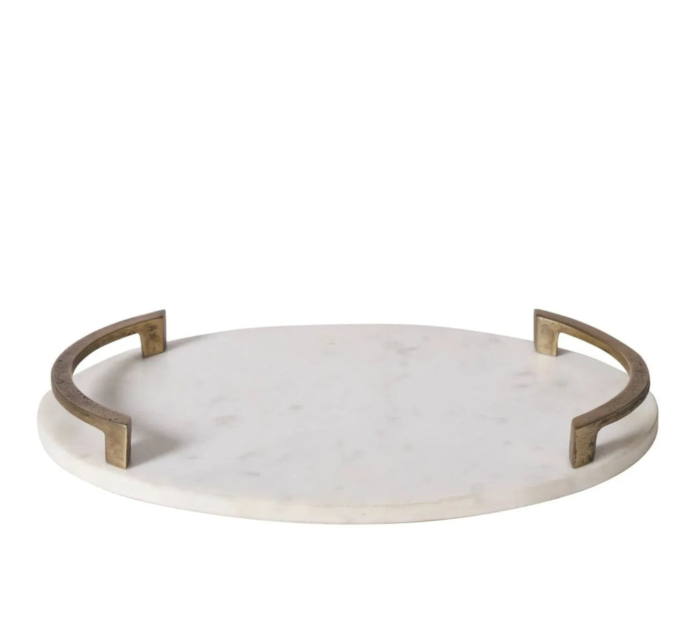 A round white marble tray with a brass handle.