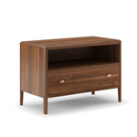 A brown king-size nightstand with one drawer and a mobile phone charger on top.