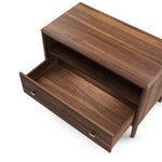 A brown wooden nightstand with a drawer and open shelf, featuring a wireless mobile phone charger on top and USB outlets.