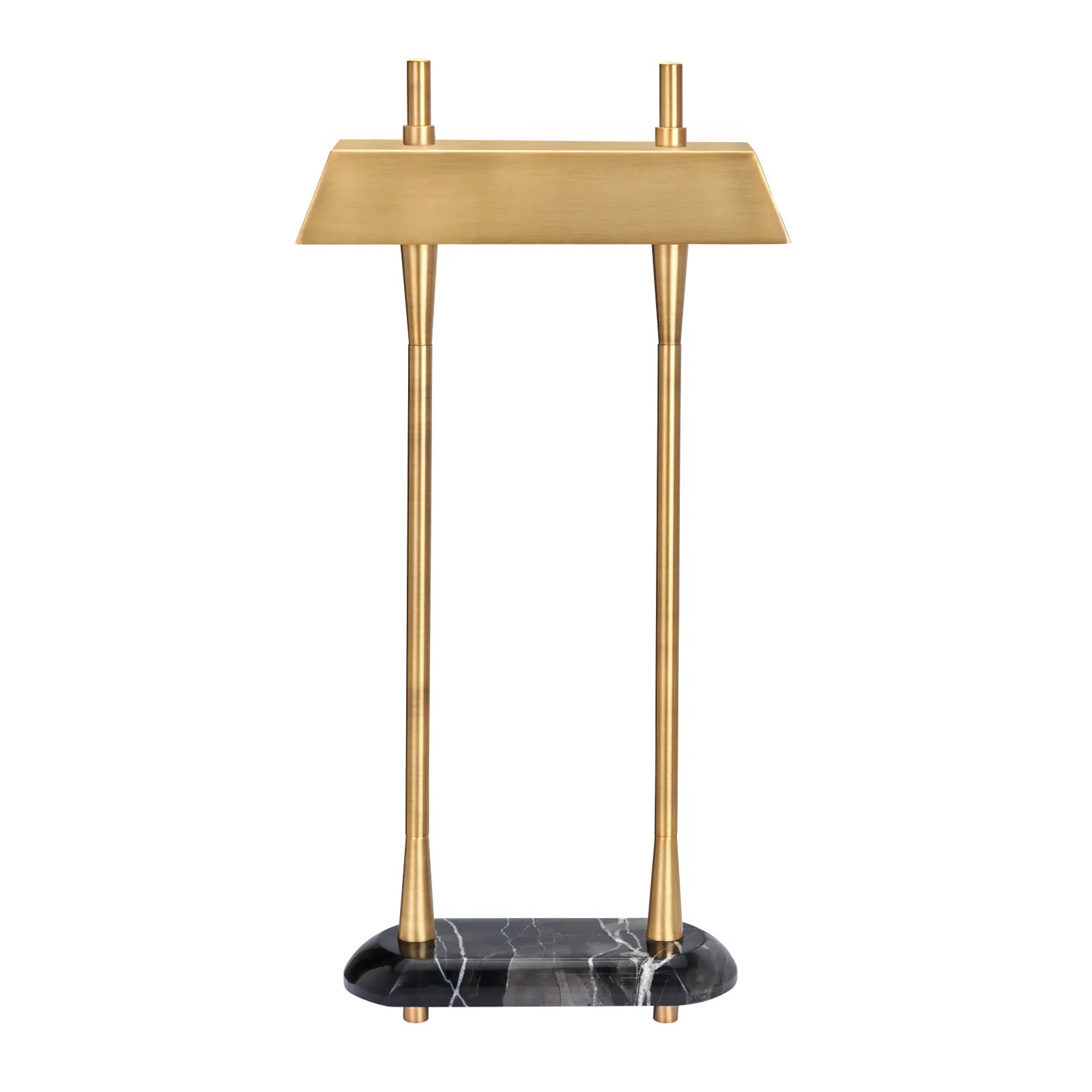 A modern table lamp with a brushed brass rectangular shade supported by two slim brass legs, standing on a black marble base with white veining, set against a plain white background.
