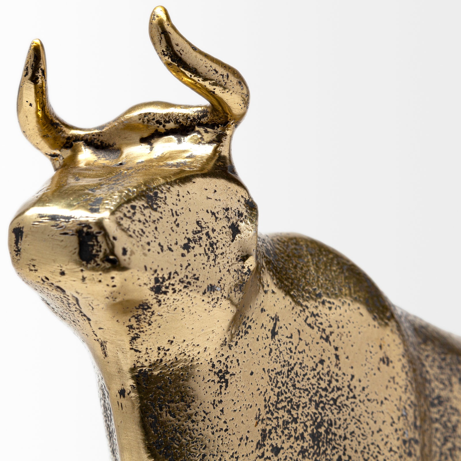 A decorative brass bull figurine with a rustic-gold polish finish.
