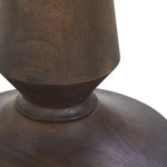 Close-up of a dark brown ceramic vase with a textured surface on a white background