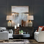 Living room with gray walls, modern furniture, and decorative items.