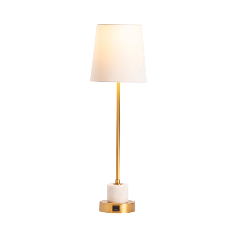 A brass marble table lamp with a white shade, gold metal stem, and a white marble base.