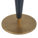 Close-up of a black cylindrical object on a gold circular base against a white background