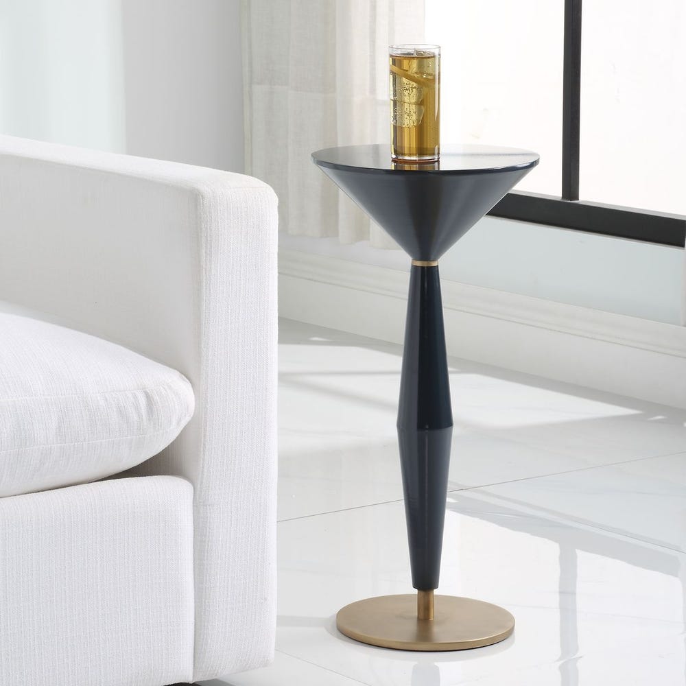 Modern side table with a glass on top in a living room setting