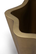 Close-up of a brown ceramic planter with a wavy edge on a white background