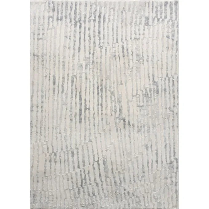 An area rug with a geometric pattern featuring ivory and grey tones.