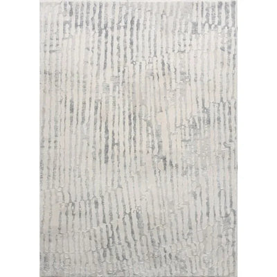 An area rug with a geometric pattern featuring ivory and grey tones.