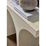 Beige textured side table with decorative items on top