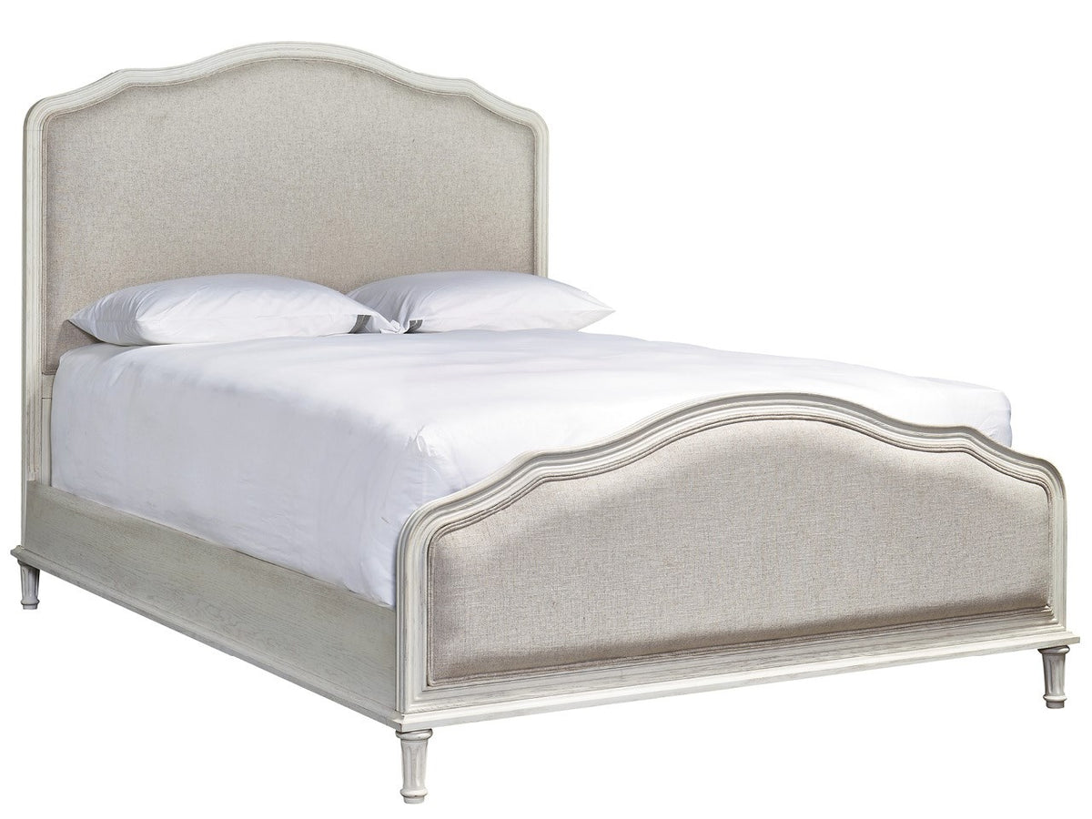 Beige upholstered bed with white bedding on a white background