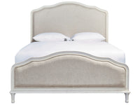Beige upholstered bed with white bedding on a white background