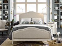 Neatly made bed in a bedroom with shelves and decor