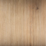 Round white marble tabletop with a wooden base featuring a geometric pattern, likely a side table.