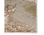 A rectangular area rug with a marble-like pattern in brown and gray tones.