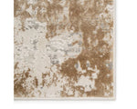 A power loomed area rug with a distressed texture design in beige and brown tones.