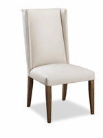 Beige upholstered chair with wooden legs on a white background