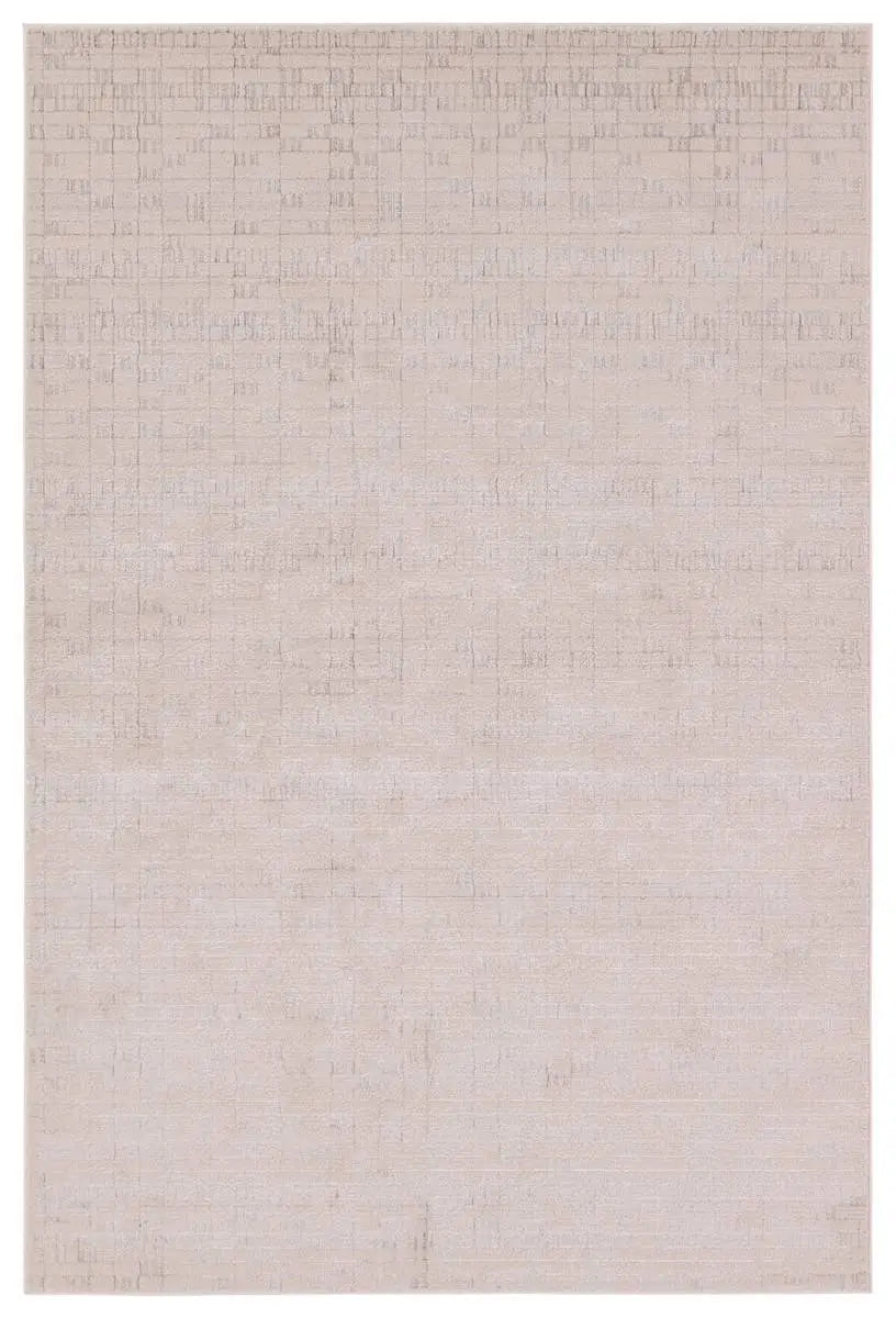 A beige area rug with a textured surface, power loomed construction, and a visible brand tag.