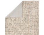A beige wool area rug with a textured weave pattern.