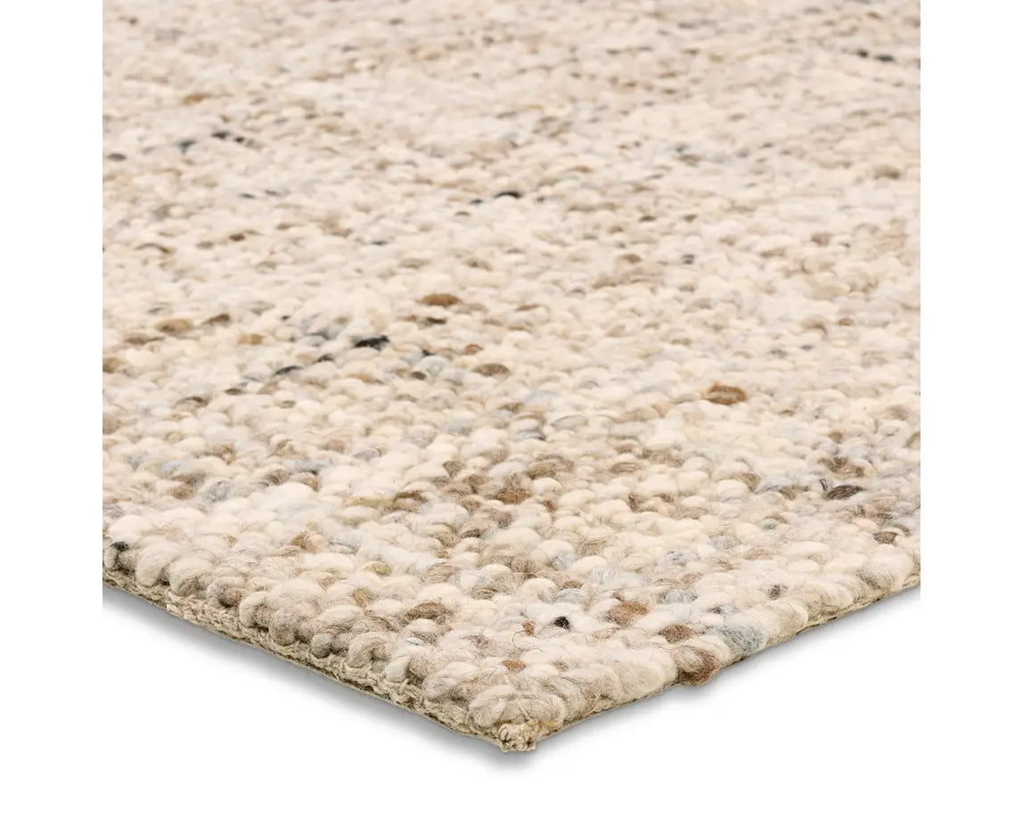 A beige wool area rug with a textured weave pattern.