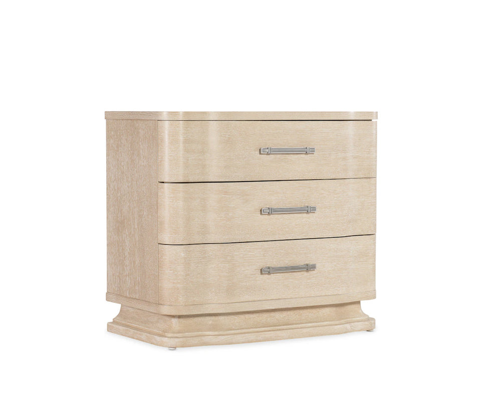 Beige three-drawer dresser with silver handles on a white background