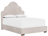 Beige upholstered bed with white mattress and pillows on a white background