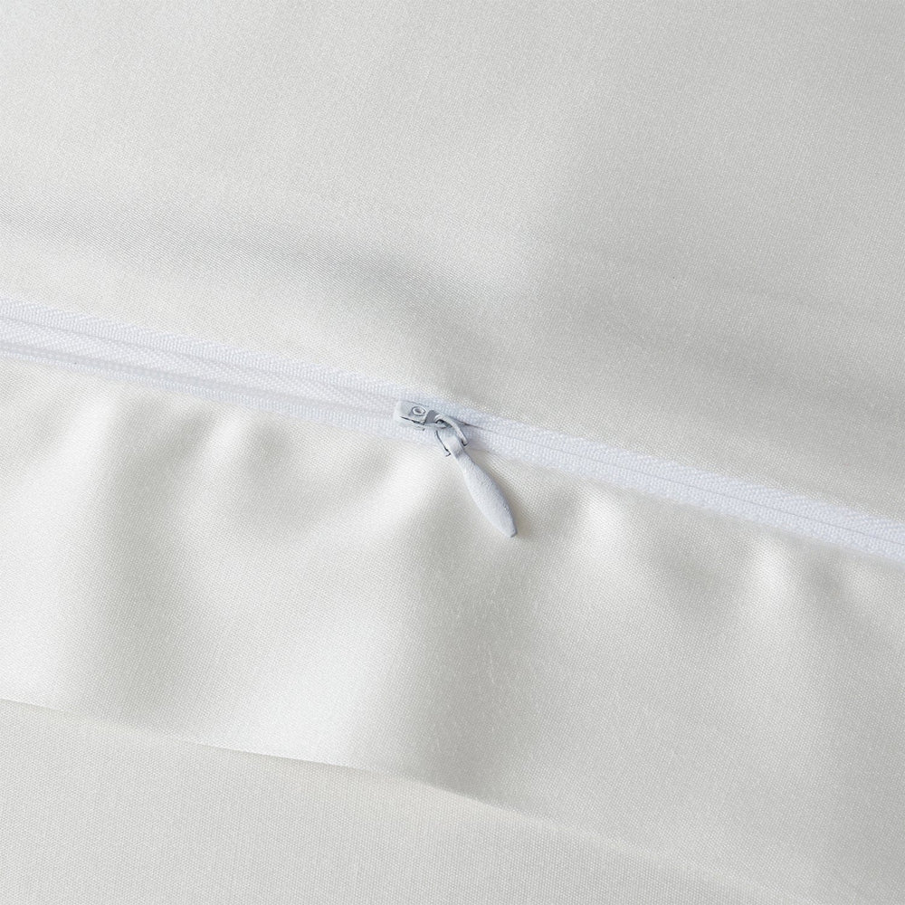 Close-up of a white zipper on a beige fabric background