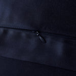 Close-up of a black zipper on a dark fabric background
