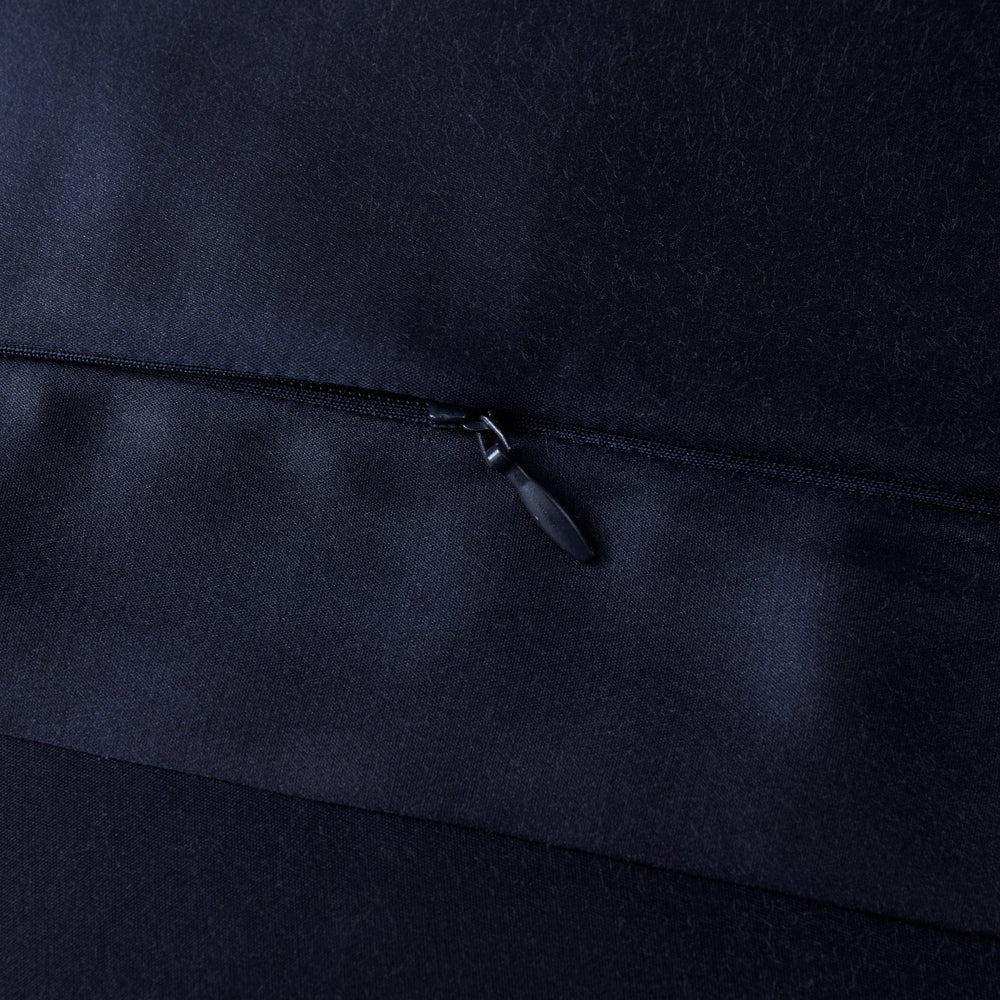 Close-up of a black zipper on a dark fabric background