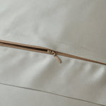 Close-up of a zipper on beige fabric