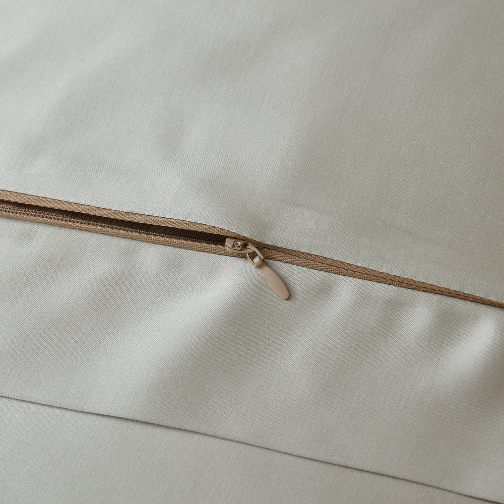 Close-up of a zipper on beige fabric