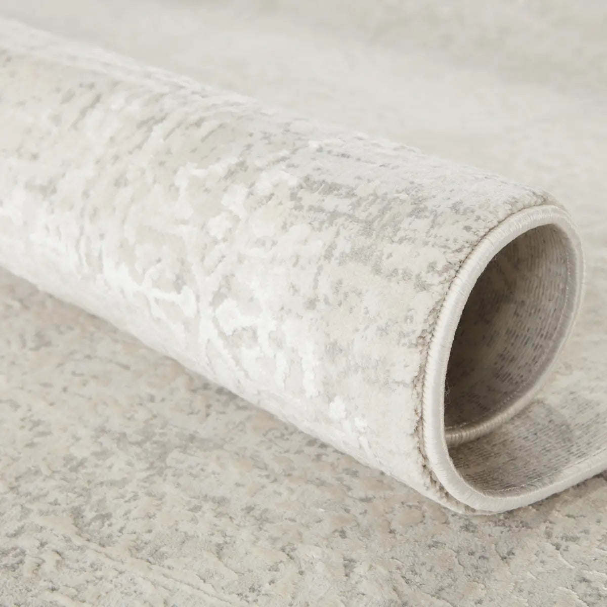 Rolled-up rug on a neutral background