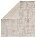 Textured area rug with a neutral color palette on a white background