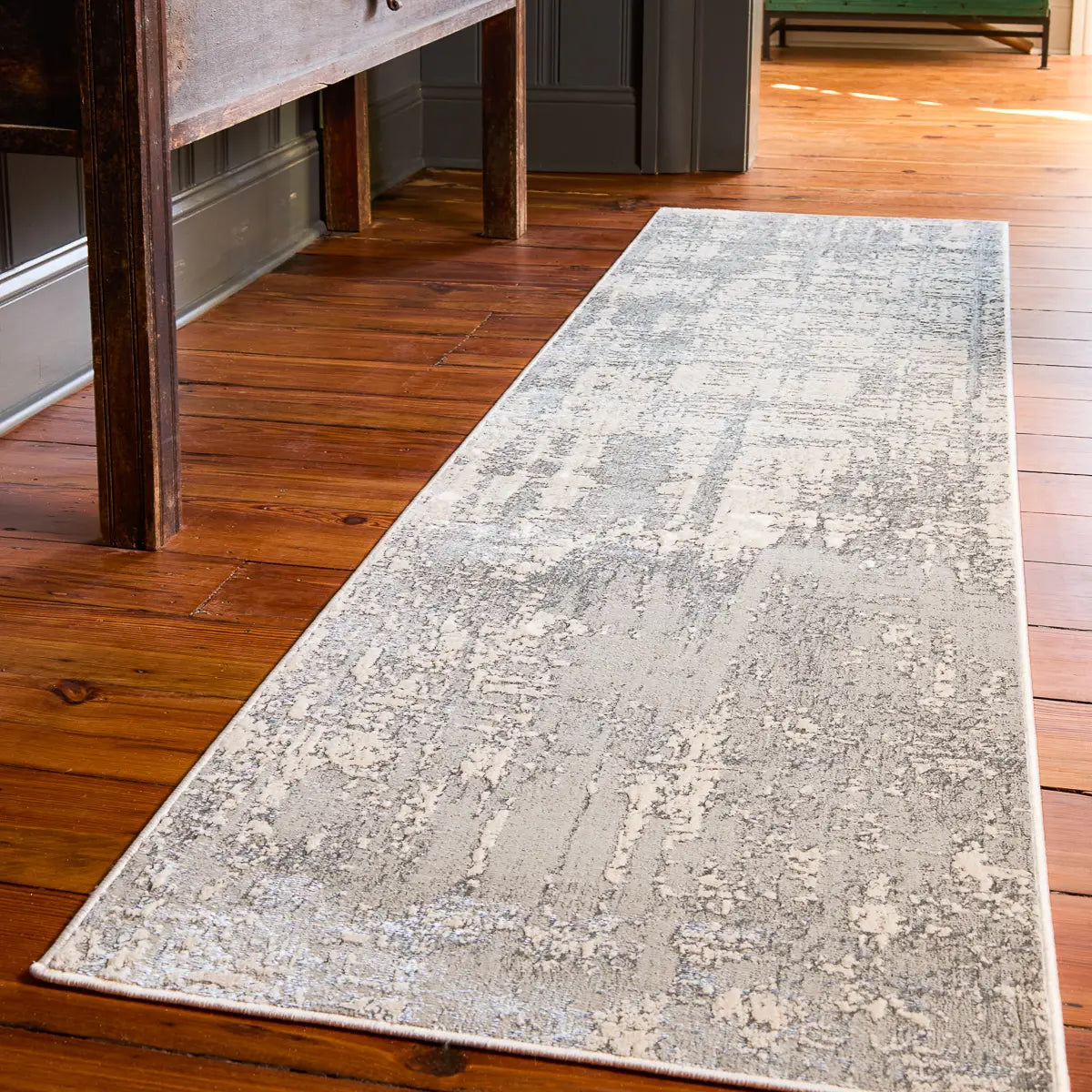 Gray patterned rug on a wooden floor