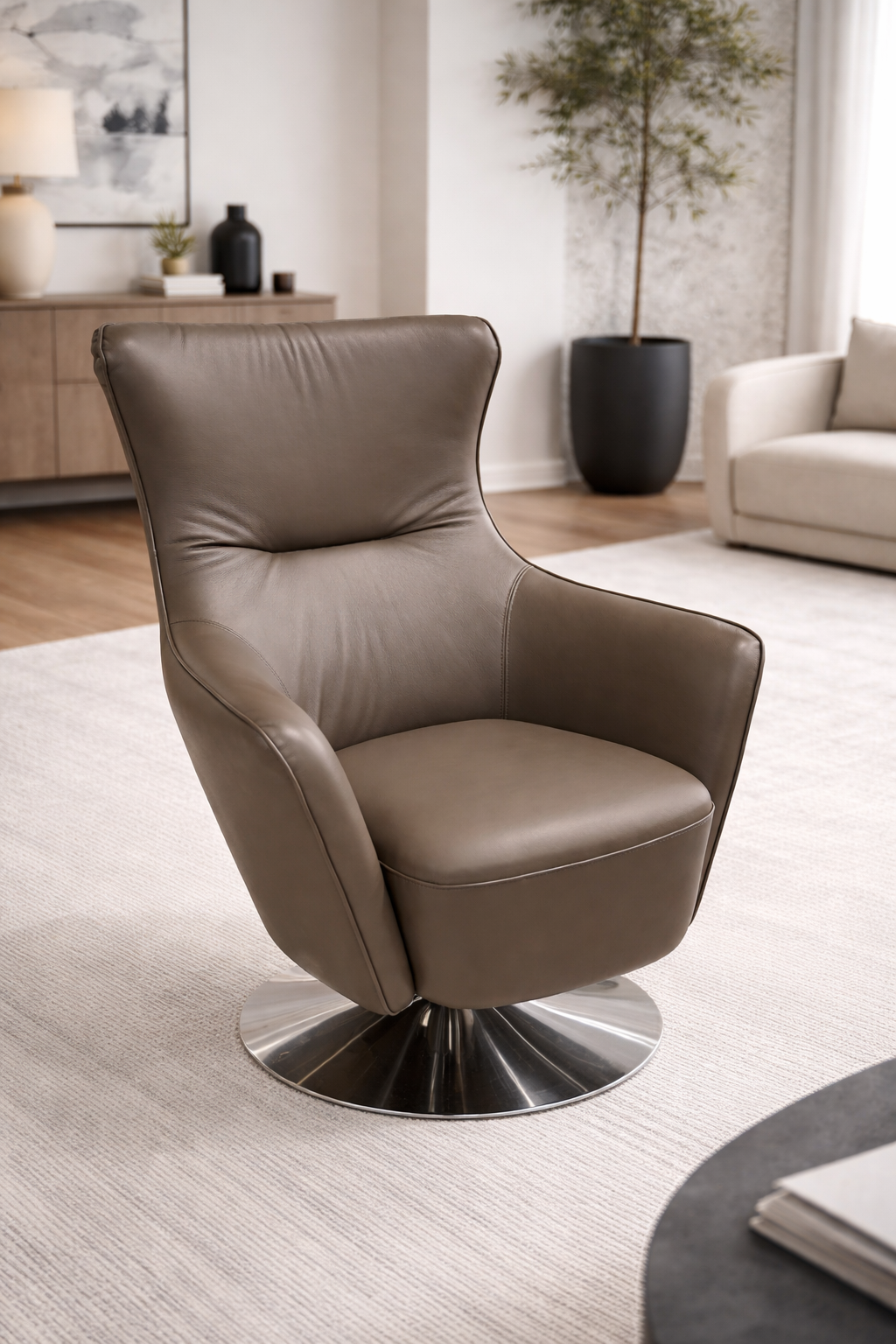 Brown leather armchair in a modern living room setting with a rug and table.