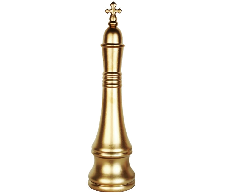 A decorative gold-colored chess king piece with a cross on top.