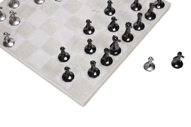 A beige marble chess board set with white and black pieces arranged on the board.