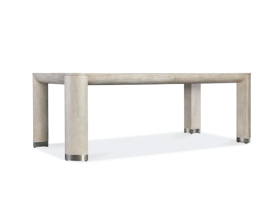 Rectangular dining table with a light wood finish on a white background