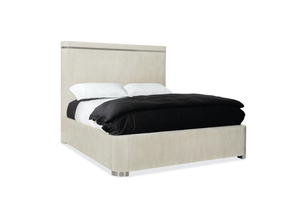 Beige upholstered bed with black bedding on a white background