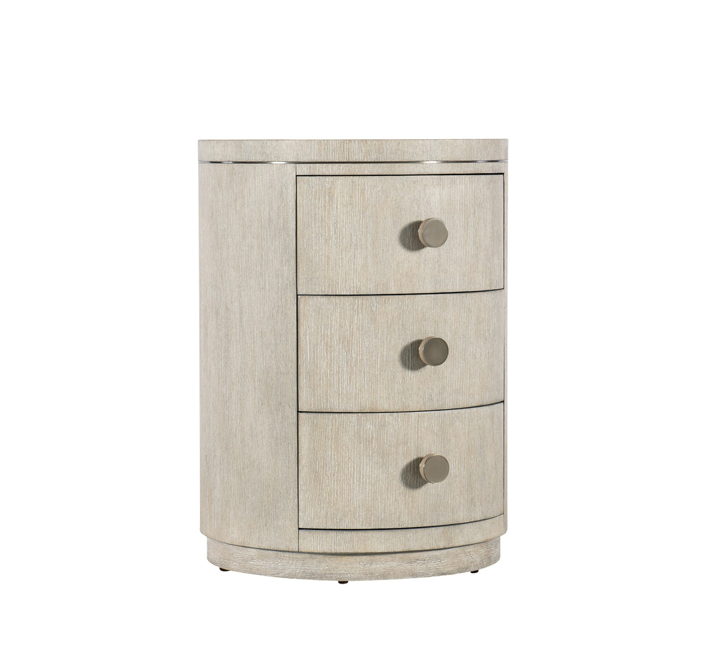 Round nightstand with three drawers on a white background