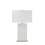 A white marble table lamp base with a natural honed finish, featuring a classic E26 socket, a dimmer switch, and an off-white linen shade, complemented by a brushed brass finished iron stem.