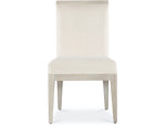 A beige upholstered dining chair with a high back and four legs.
