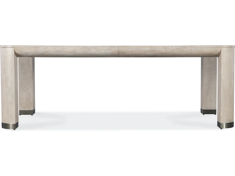 Dining table with a light wood finish on a white background