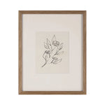Framed artwork with a black line drawing of a floral design on a beige background